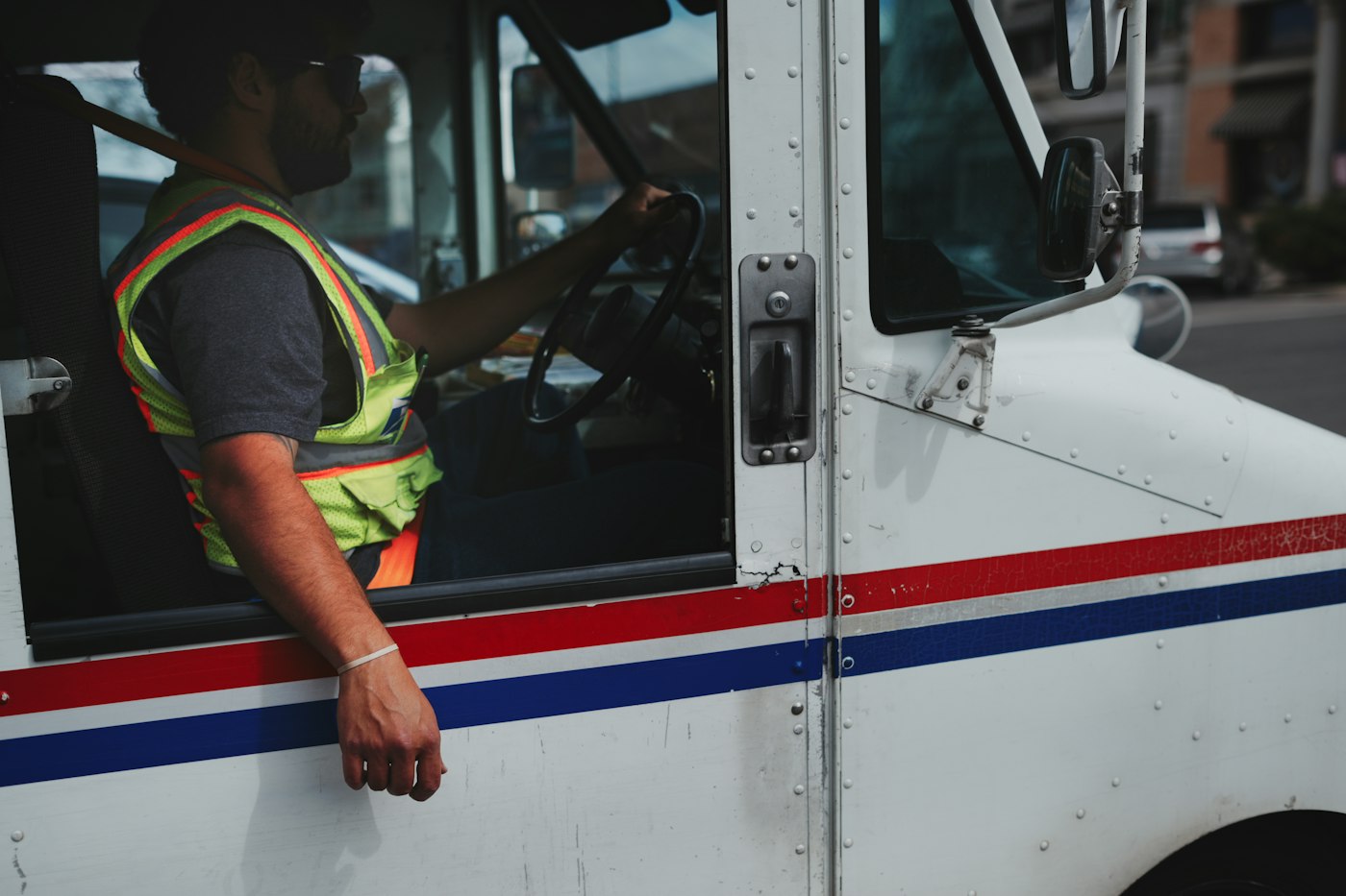 Mail carrier at work in a delivery truck